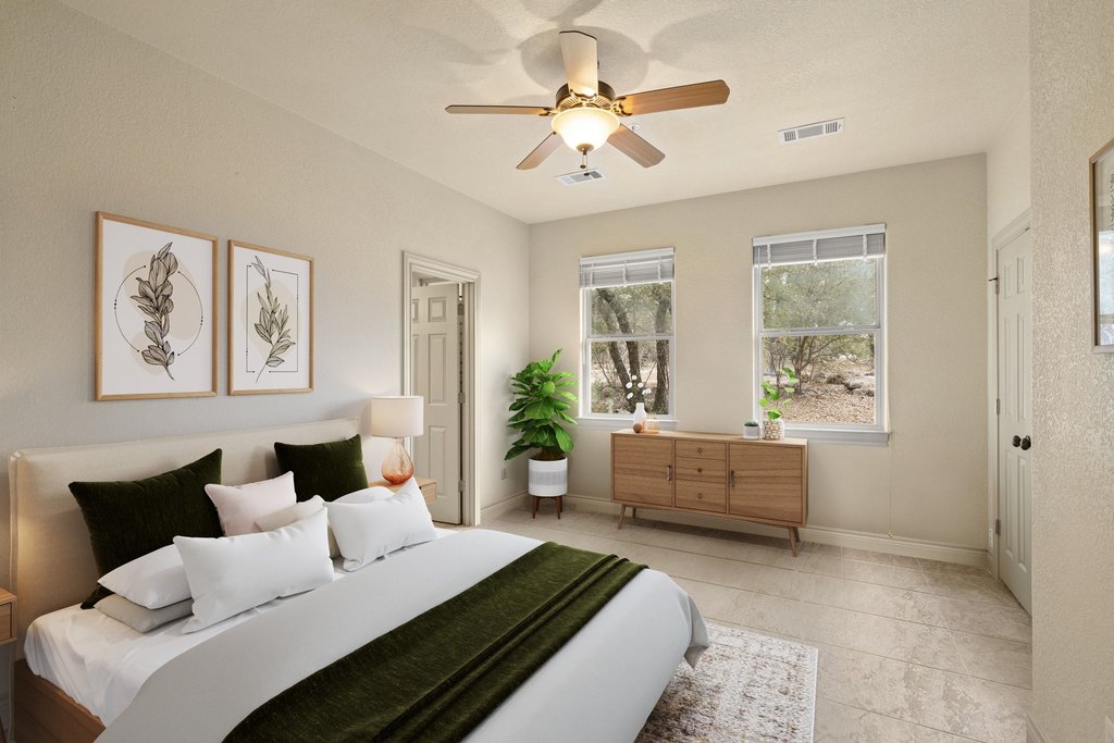 232 Crooked Oak Round Mountain, TX 78663 - Photo 23 of 40 a bedroom with a large bed and a couch