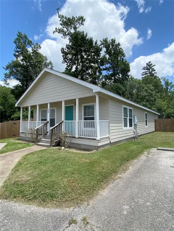 a front view of house with yard outdoor seating and green space