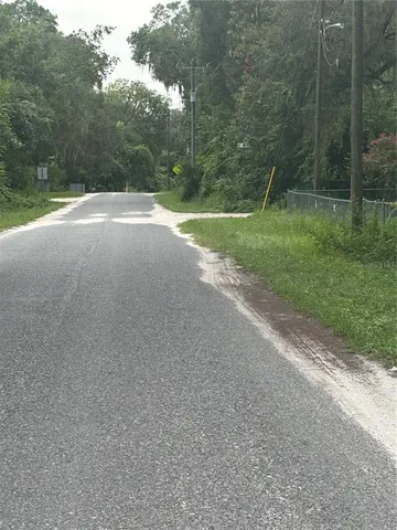 a view of a field with a trees in it