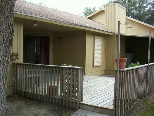 a view of a house with a wooden deck