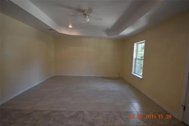 an empty room with a empty space and windows