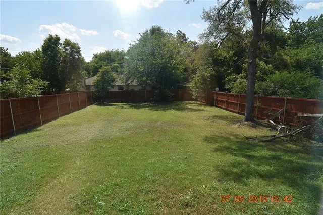 a backyard of a house with lots of green space