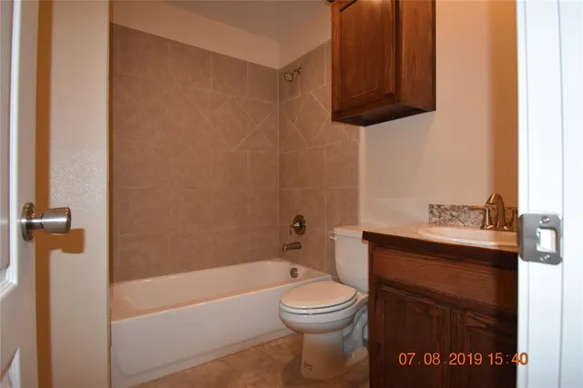 a bathroom with a toilet a sink and bathtub