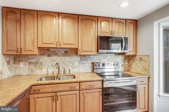 a kitchen with appliances cabinets and a sink