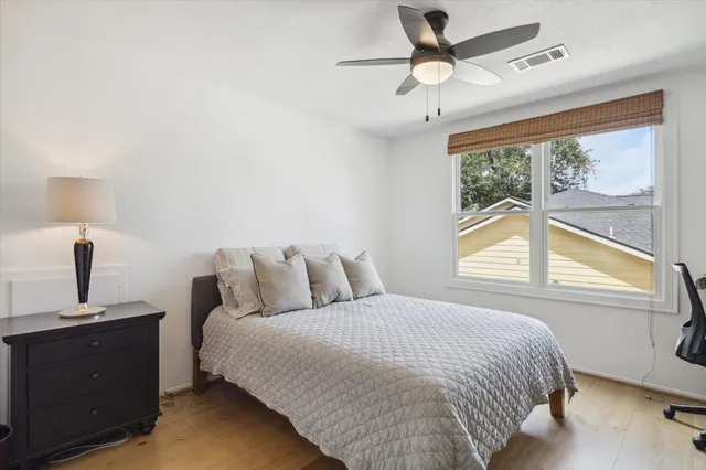 a bedroom with a bed and a window