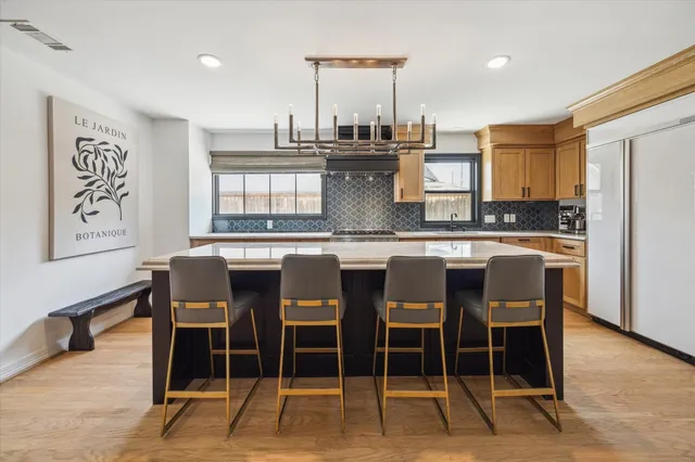 a large kitchen with a table and chairs