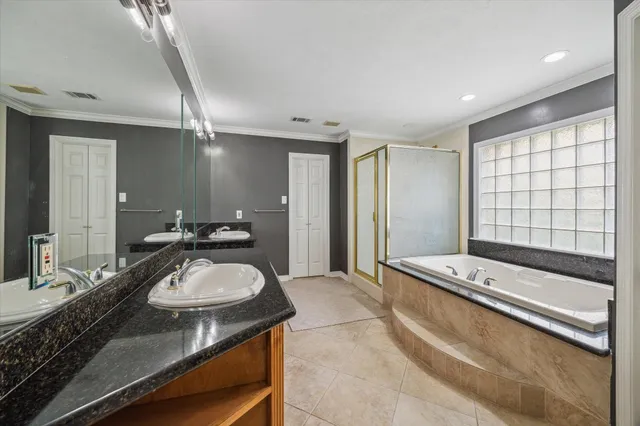 a bathroom with a granite countertop sink a large mirror and shower