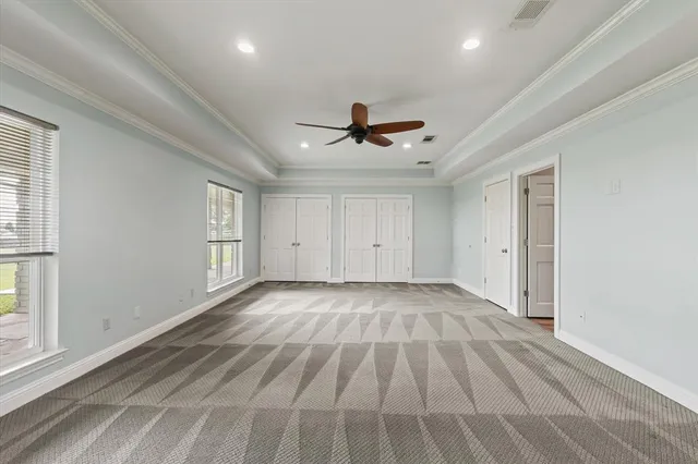 a bathroom with a granite countertop sink a toilet and a mirror