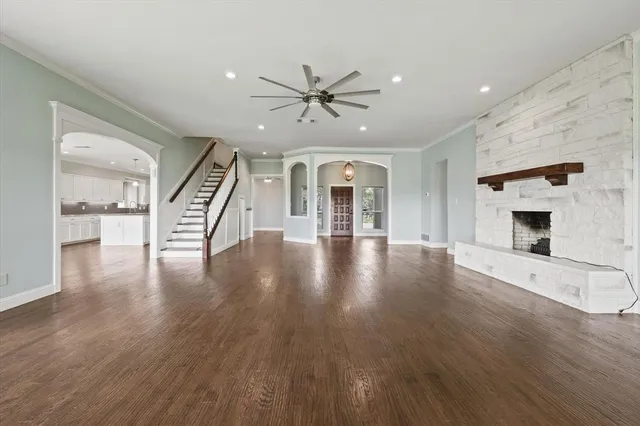wooden floor in an empty room with a fireplace