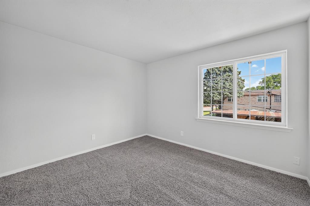 1801 East Grauwyler Road, Unit 101 Irving, TX 75061 - Photo 18 of 39 wooden floor in an empty room with a window