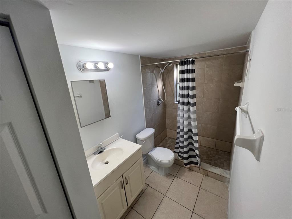 1916 Honour Road, Unit 1 Orlando, FL 32839 - Photo 17 of 20 a bathroom with a sink a toilet and shower