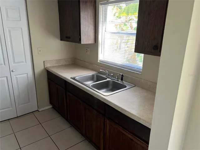 a kitchen with a sink cabinets and window