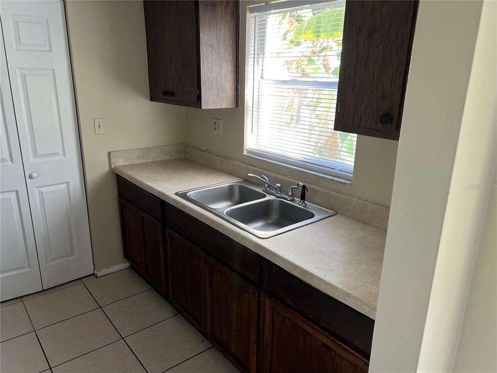 1916 Honour Road, Unit 1 Orlando, FL 32839 - Photo 5 of 20 a kitchen with a sink cabinets and window