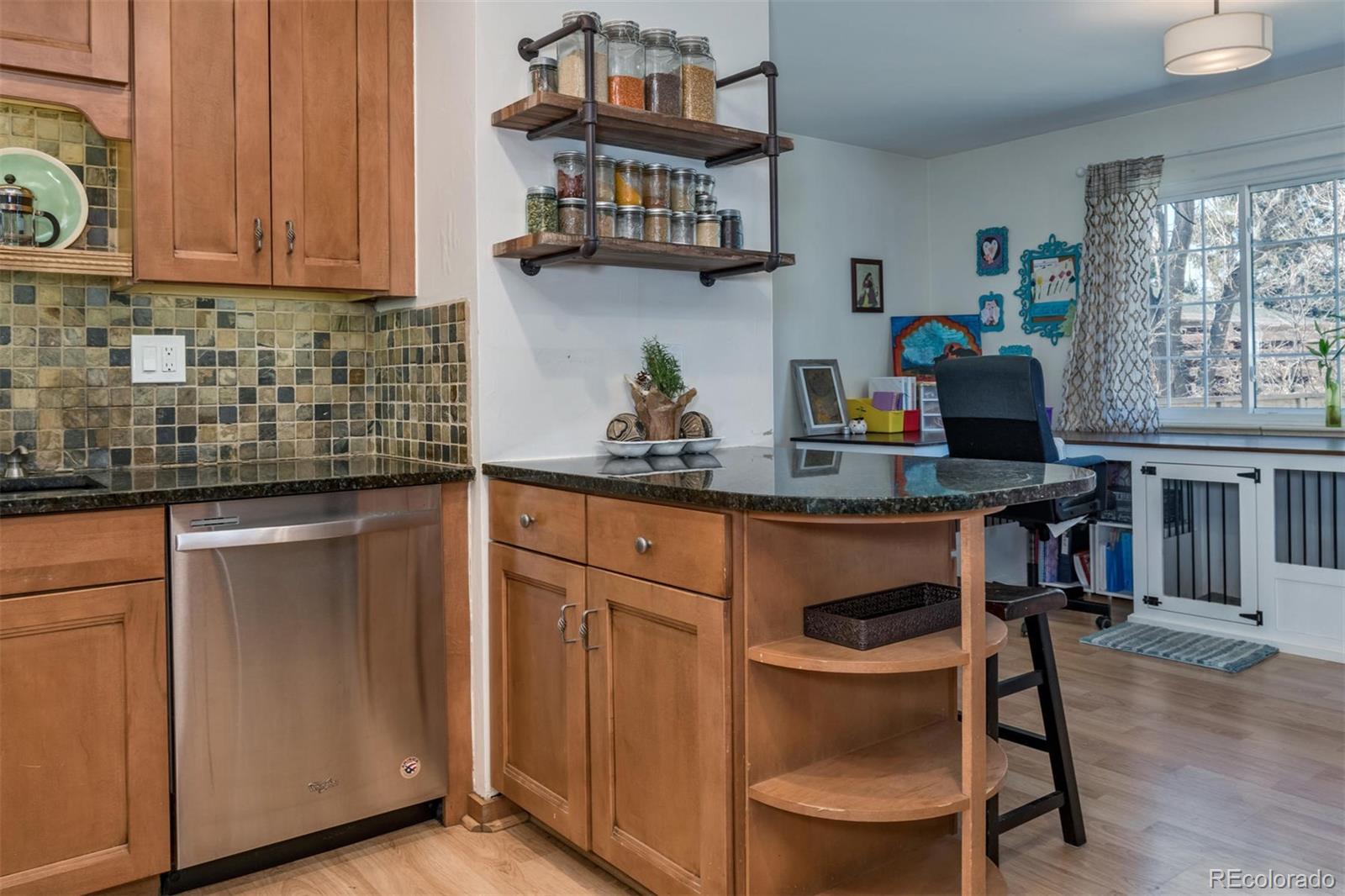 3435 Ward Road Wheat Ridge, CO 80033 - Photo 13 of 32 a kitchen with stainless steel appliances granite countertop a refrigerator and a stove top oven