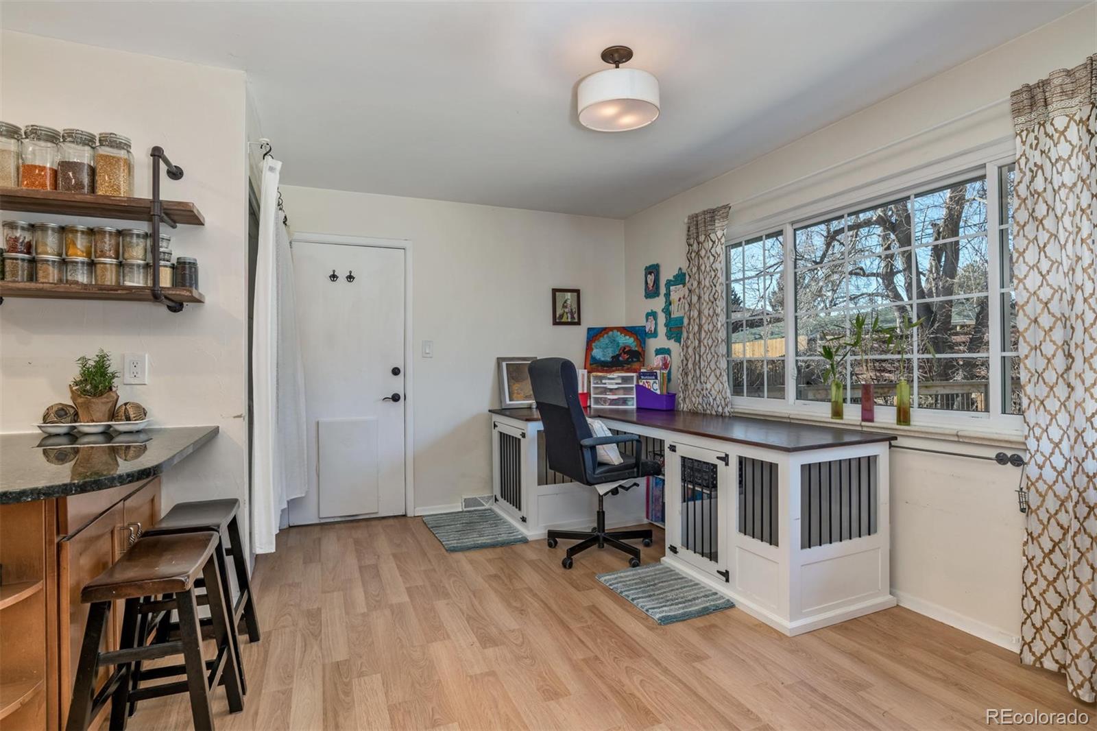 3435 Ward Road Wheat Ridge, CO 80033 - Photo 15 of 32 a view of a workspace with furniture and a window