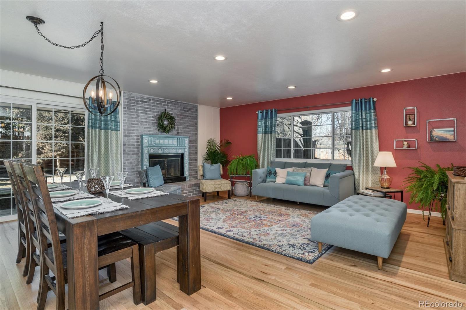 3435 Ward Road Wheat Ridge, CO 80033 - Photo 2 of 32 a living room with furniture a window and a fireplace
