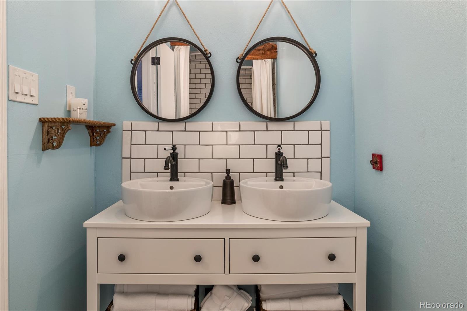 3435 Ward Road Wheat Ridge, CO 80033 - Photo 21 of 32 a bathroom with a sink and a mirror