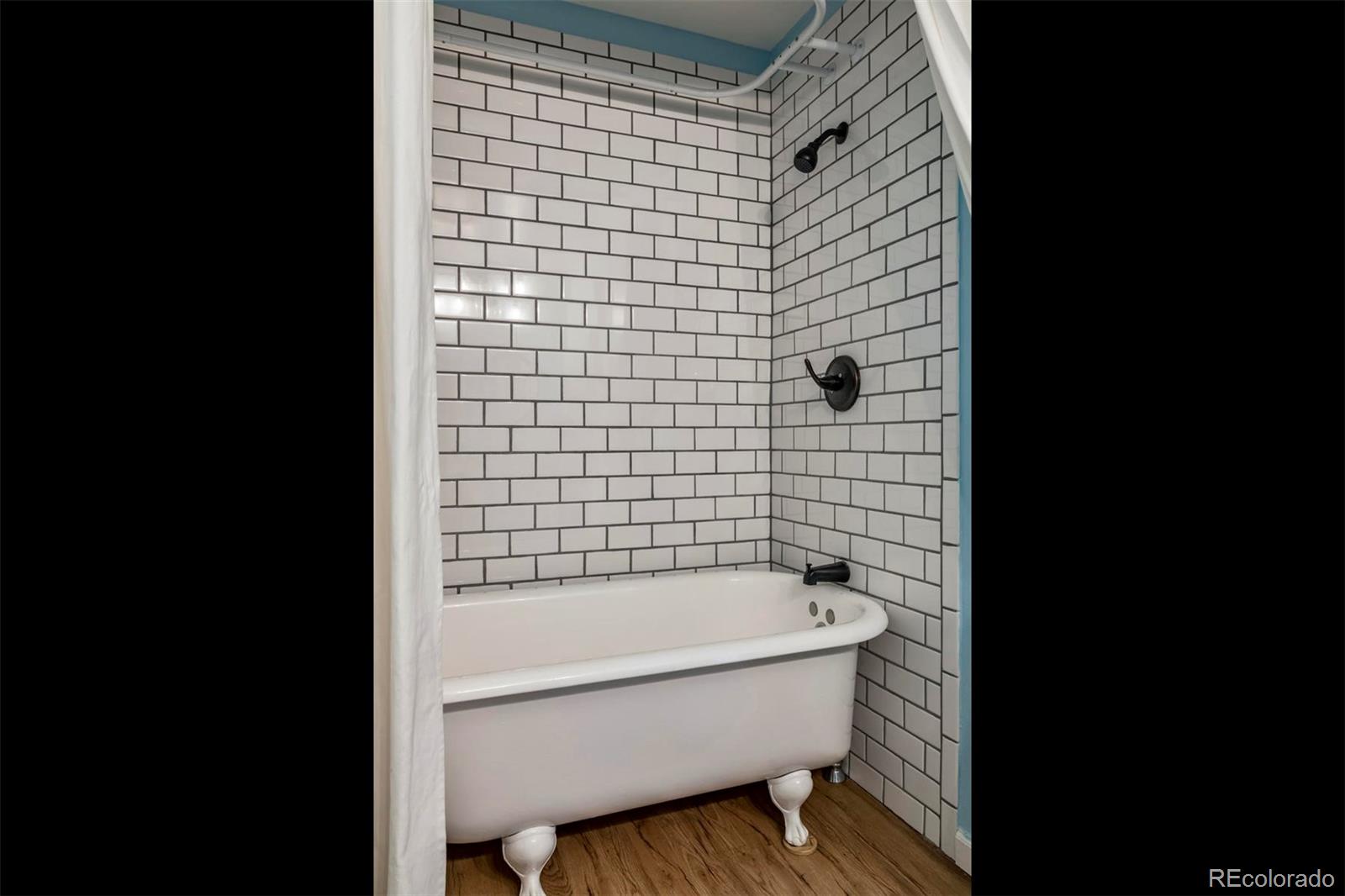 3435 Ward Road Wheat Ridge, CO 80033 - Photo 24 of 32 a bathroom with a bathtub and shower