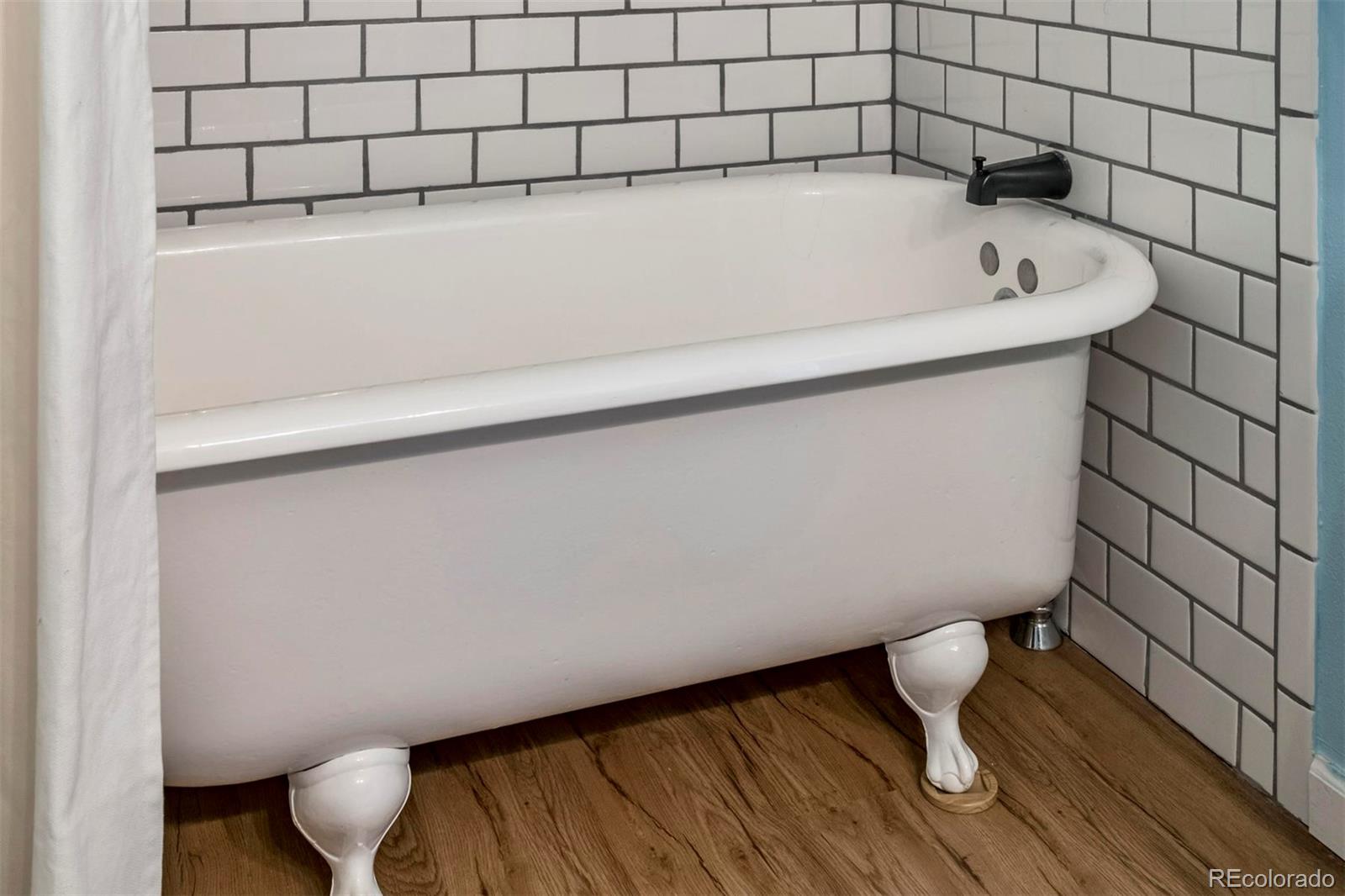 3435 Ward Road Wheat Ridge, CO 80033 - Photo 25 of 32 a bathroom with a bathtub