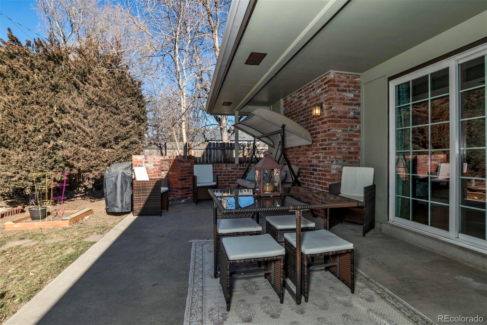 3435 Ward Road Wheat Ridge, CO 80033 - Photo 27 of 32 a view of a chairs and table in the back yard of the house