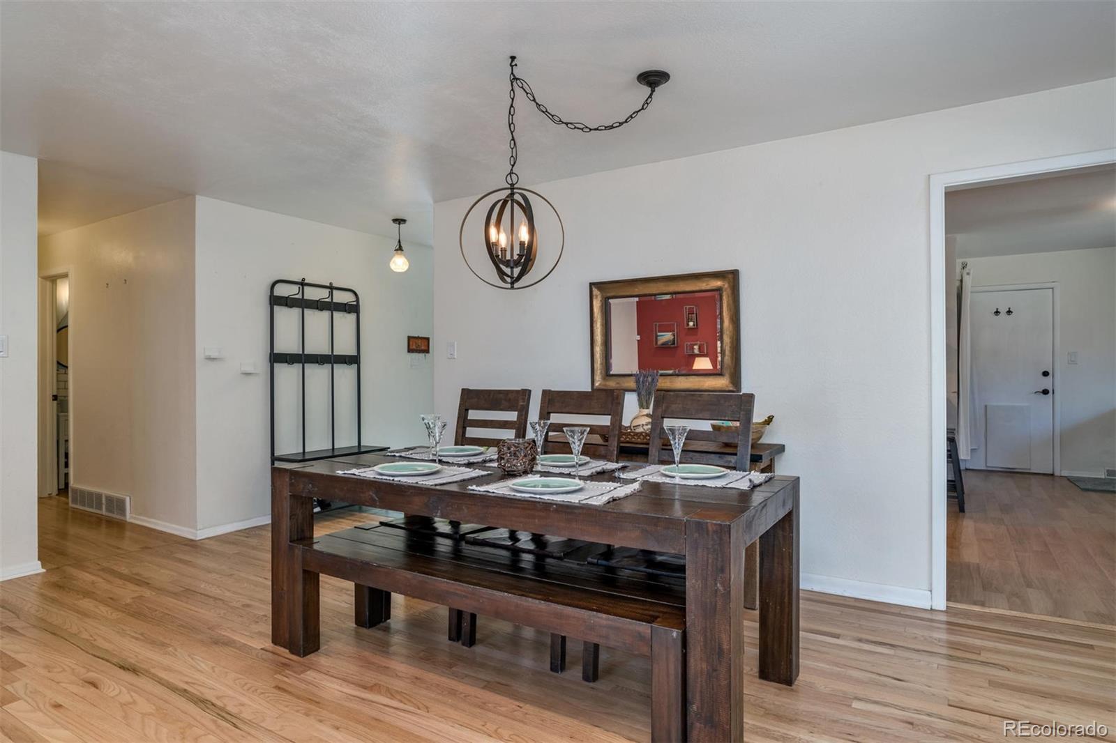 3435 Ward Road Wheat Ridge, CO 80033 - Photo 6 of 32 a view of a kitchen area with furniture and wooden floor