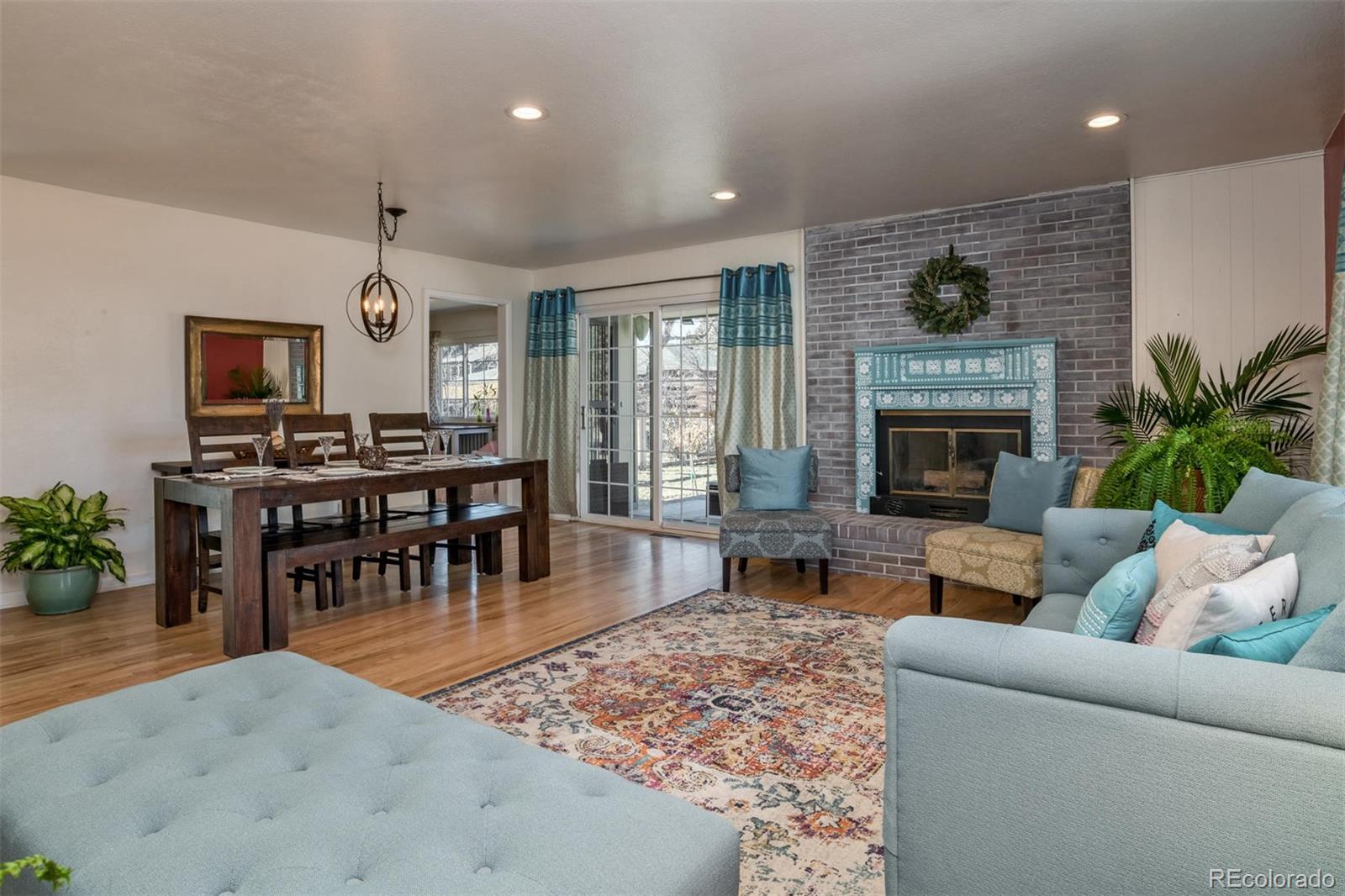 3435 Ward Road Wheat Ridge, CO 80033 - Photo 7 of 32 a living room with furniture and a fireplace