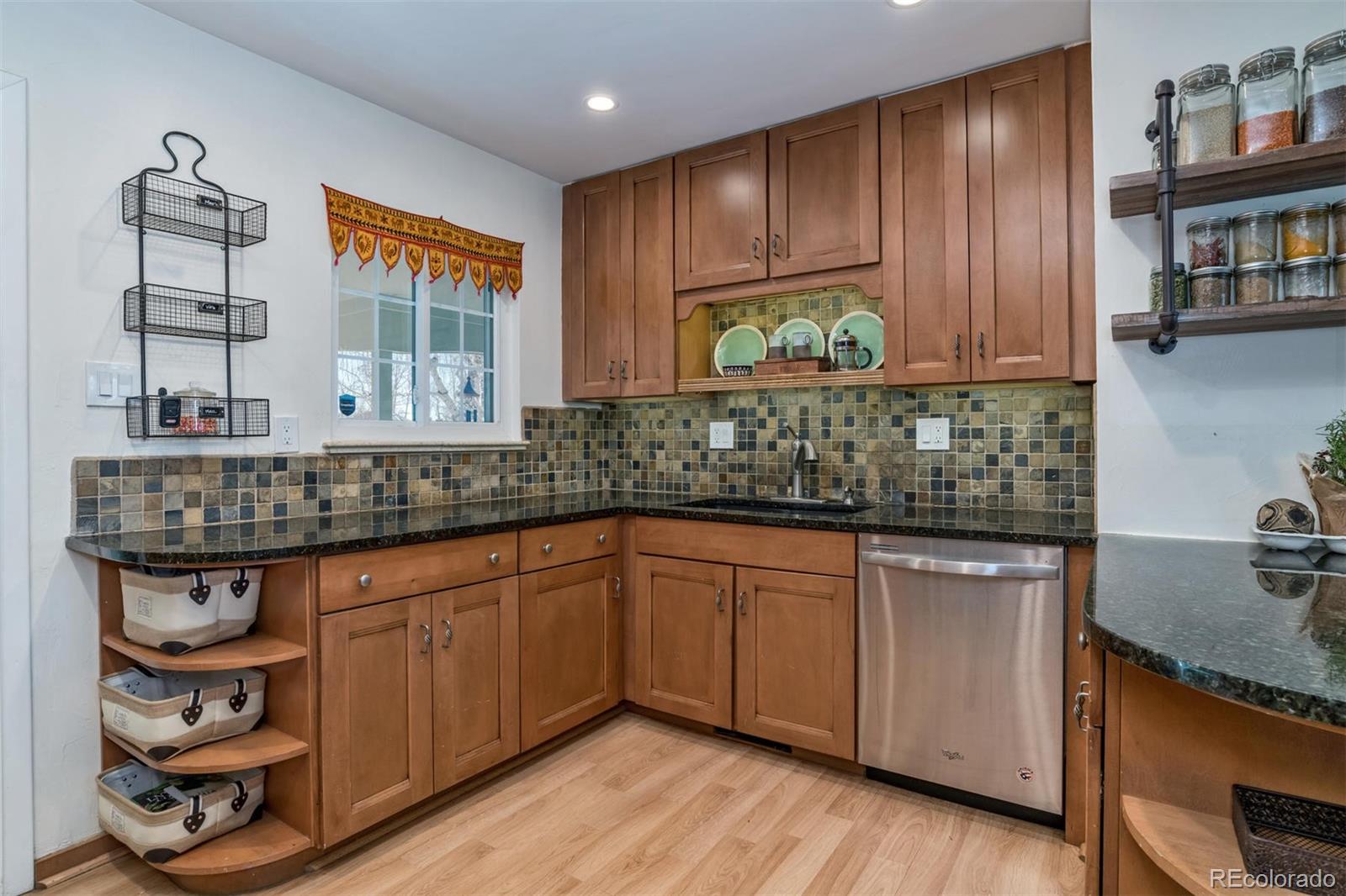 3435 Ward Road Wheat Ridge, CO 80033 - Photo 10 of 32 a kitchen with stainless steel appliances granite countertop wooden cabinets a sink and dishwasher
