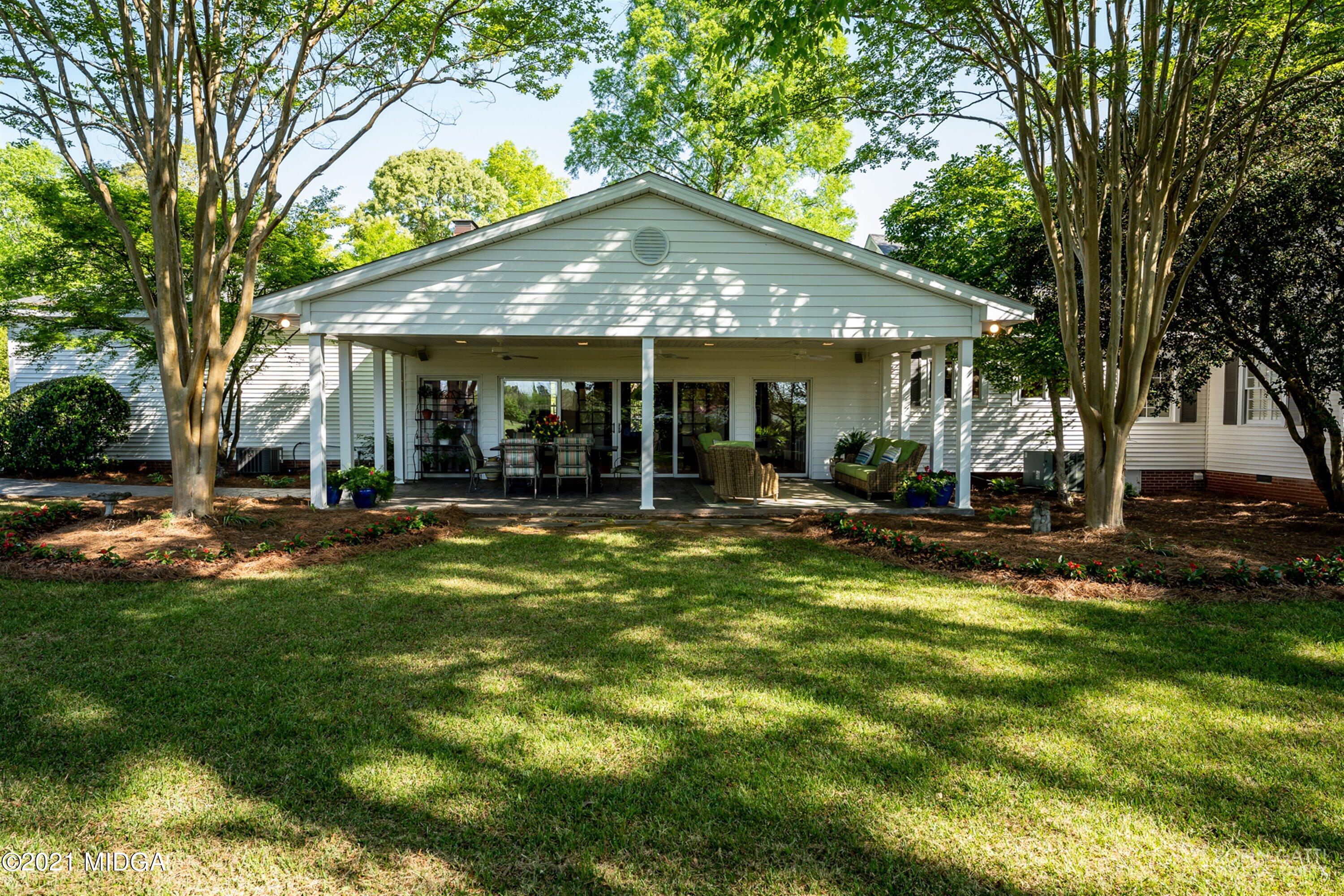 2569 Maynards Mill Road Forsyth, GA 31029 - Photo 11 of 67 a backyard of a house with yard and outdoor seating