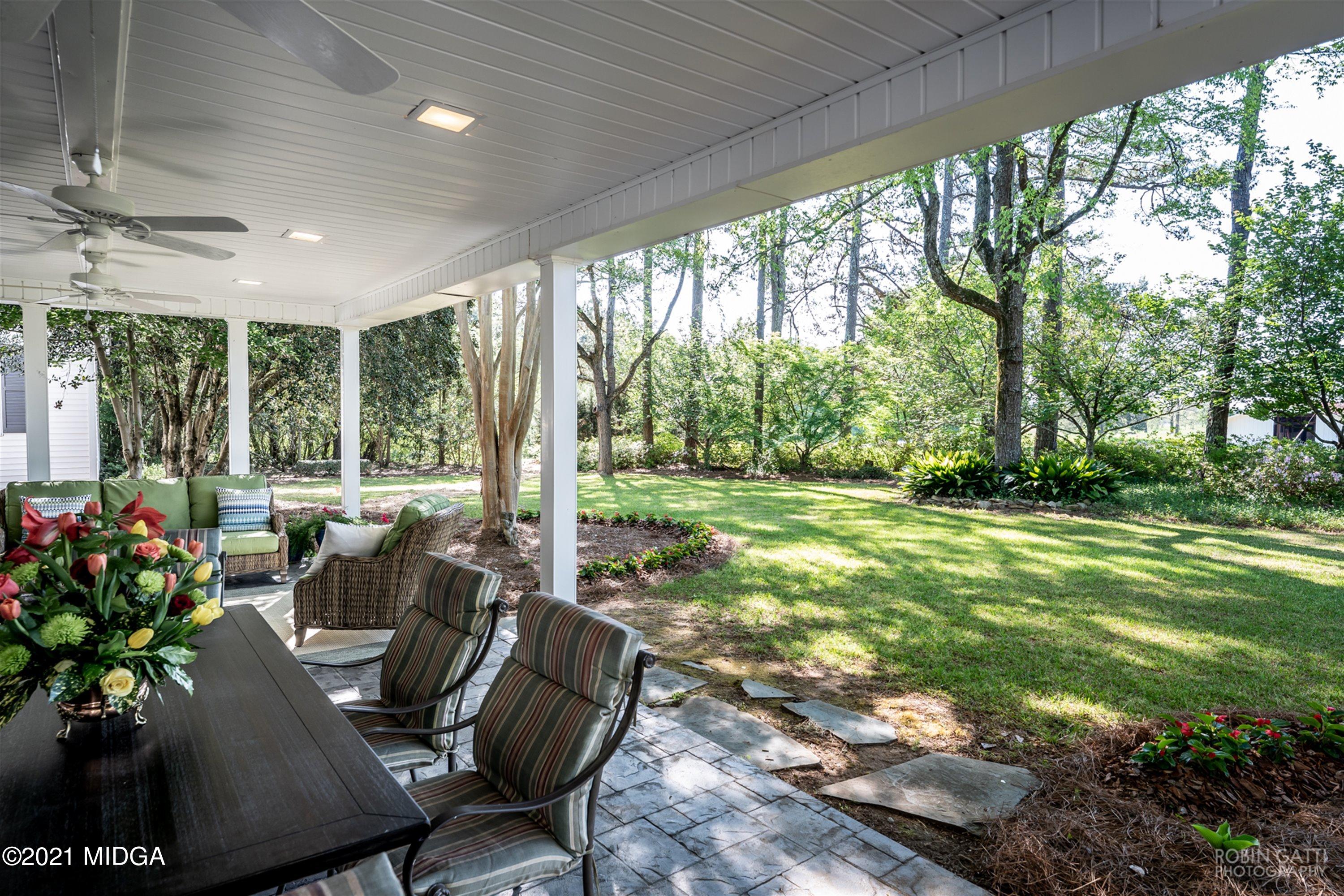 2569 Maynards Mill Road Forsyth, GA 31029 - Photo 14 of 67 a view of a patio with a table chairs and a backyard