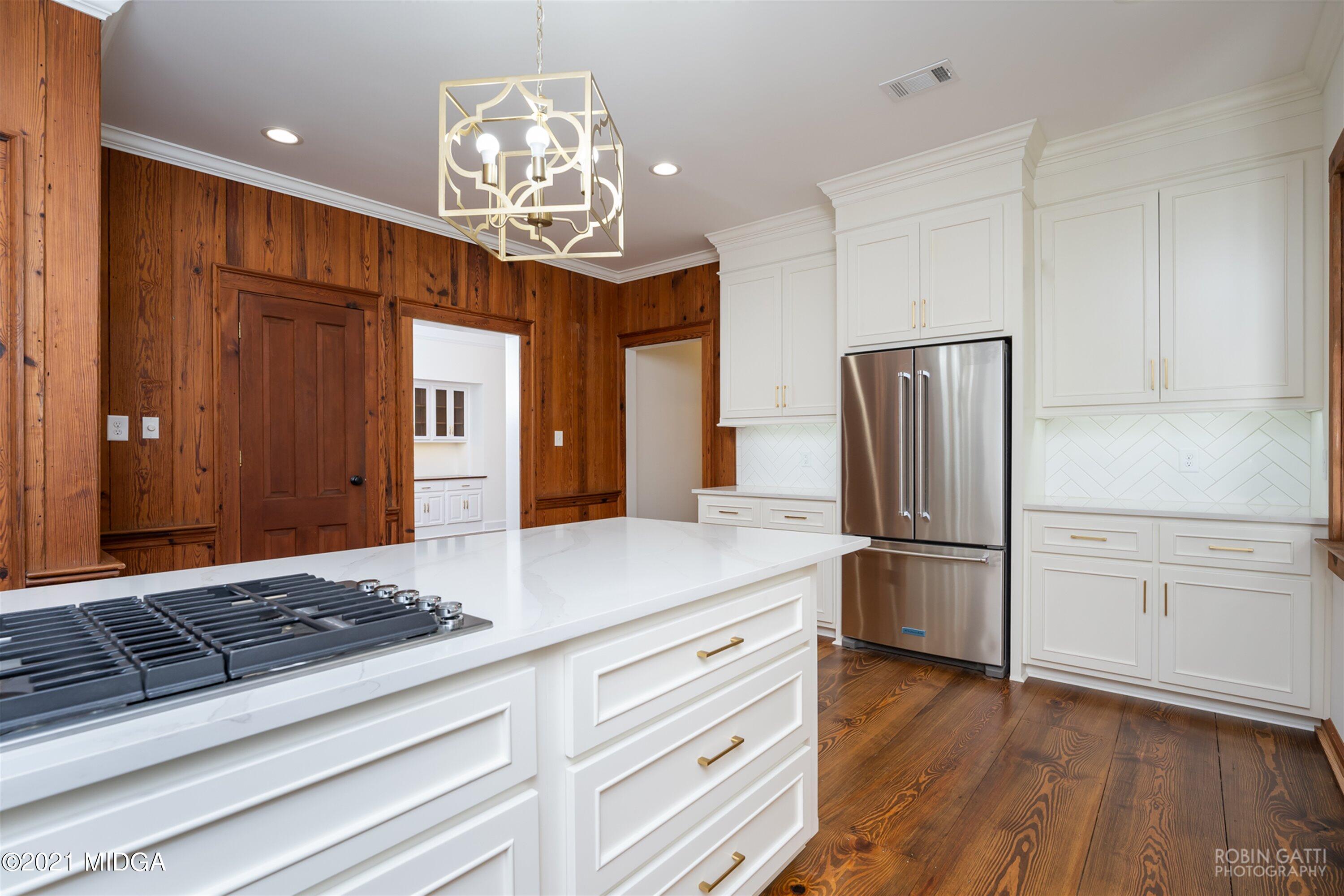 2569 Maynards Mill Road Forsyth, GA 31029 - Photo 27 of 67 a kitchen with stainless steel appliances a refrigerator and a stove top oven