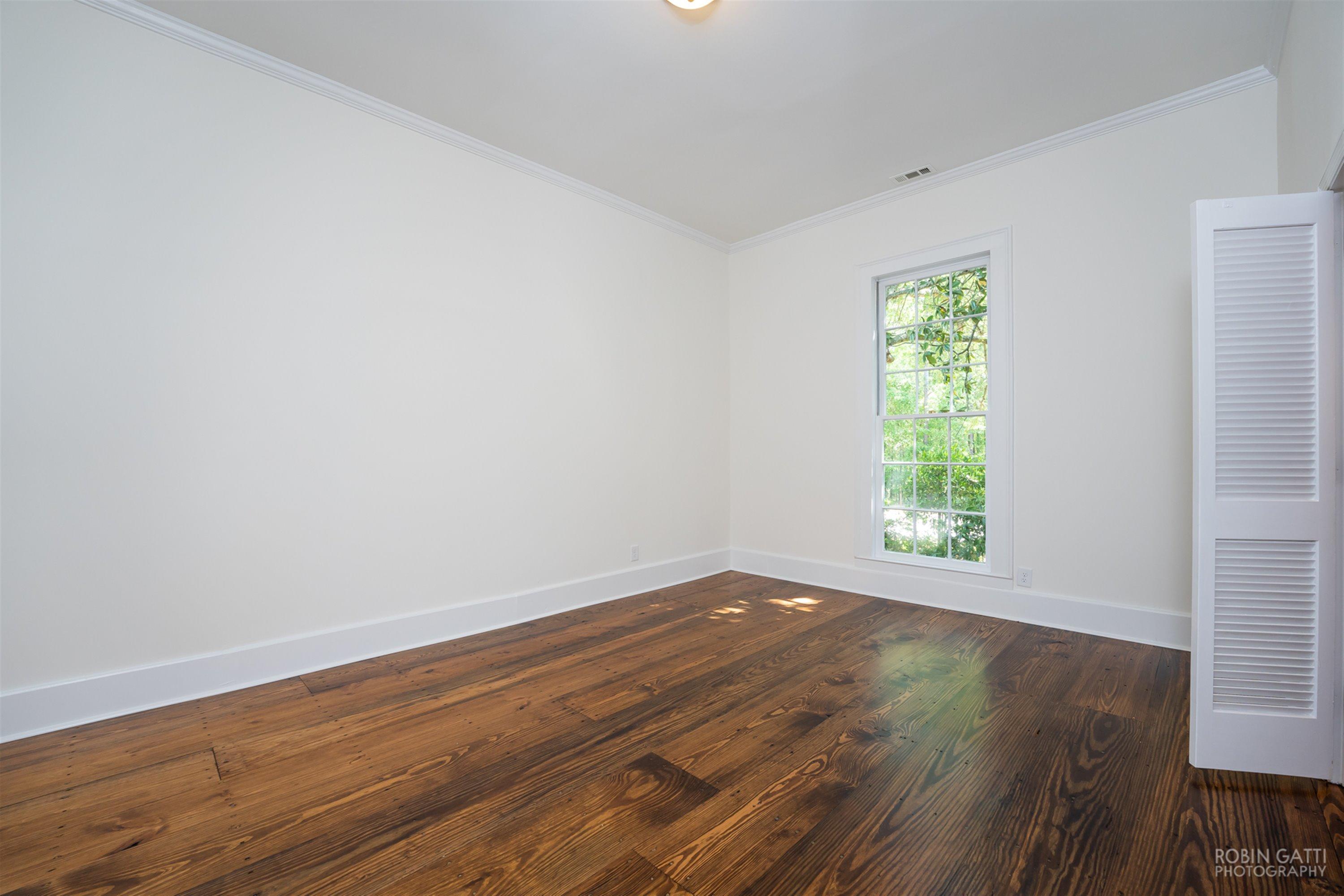2569 Maynards Mill Road Forsyth, GA 31029 - Photo 38 of 67 a view of an empty room with wooden floor and a window