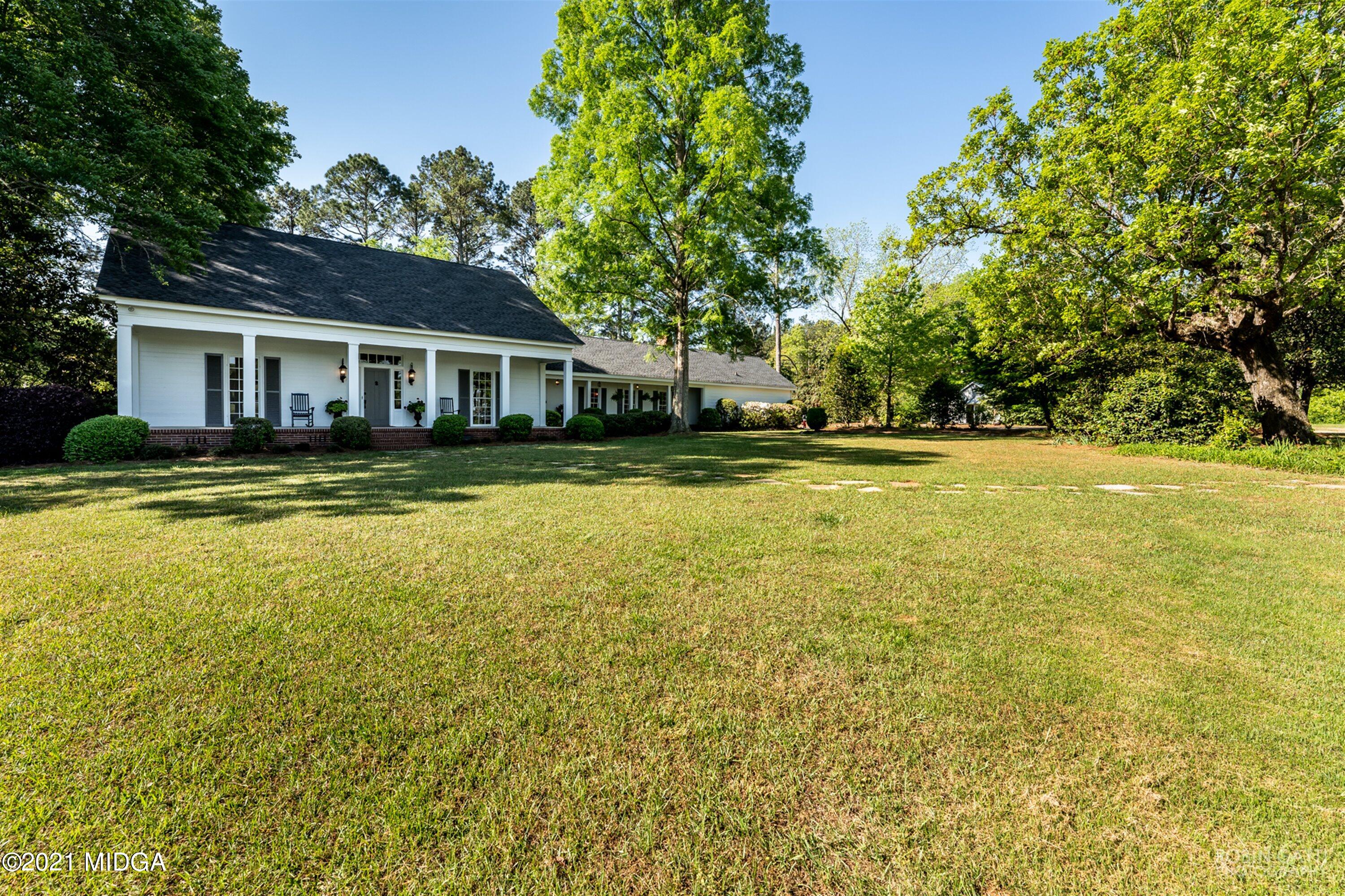 2569 Maynards Mill Road Forsyth, GA 31029 - Photo 5 of 67 a view of a house with a big yard and palm trees