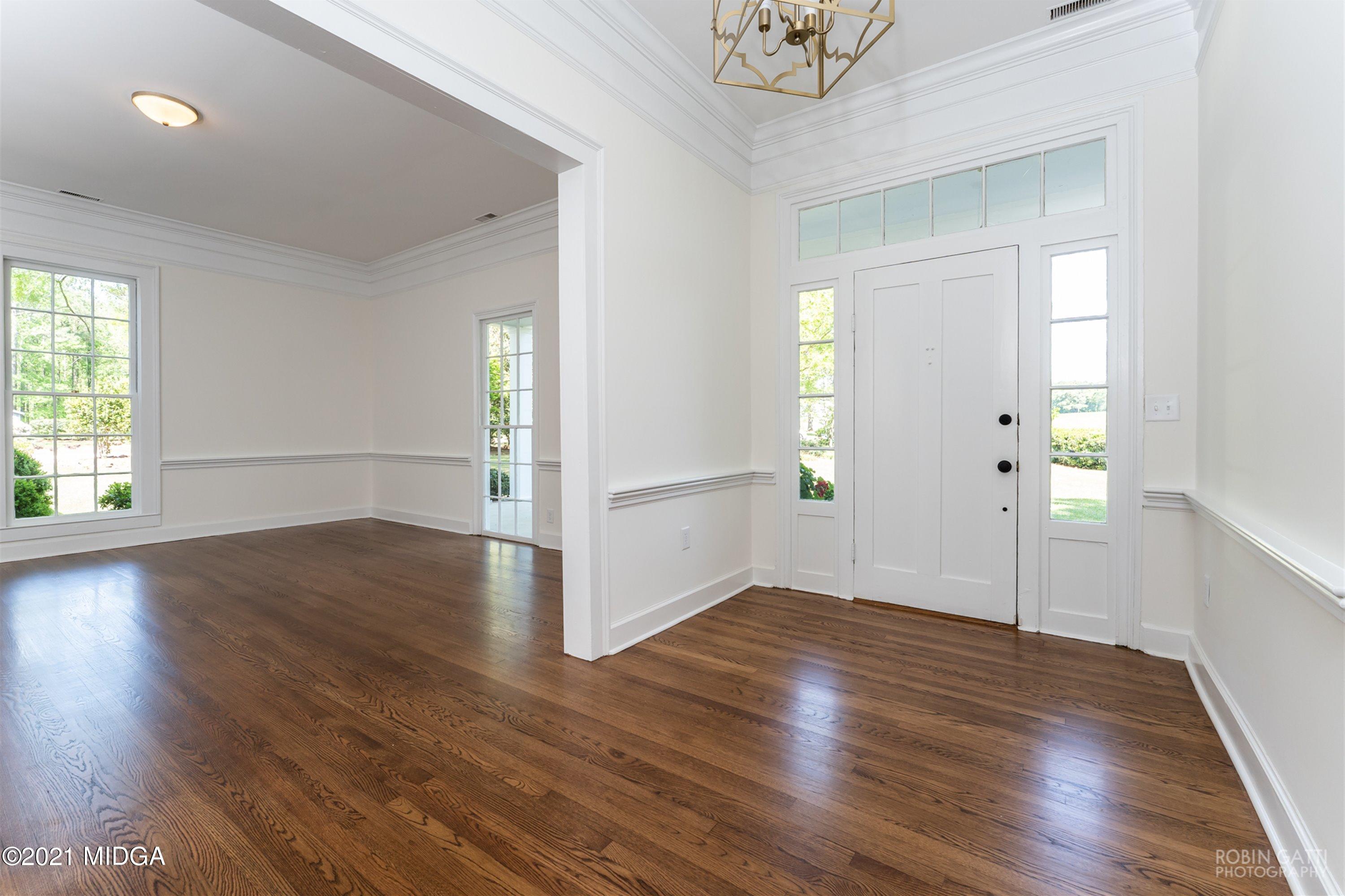 2569 Maynards Mill Road Forsyth, GA 31029 - Photo 43 of 67 an empty room with wooden floor and windows