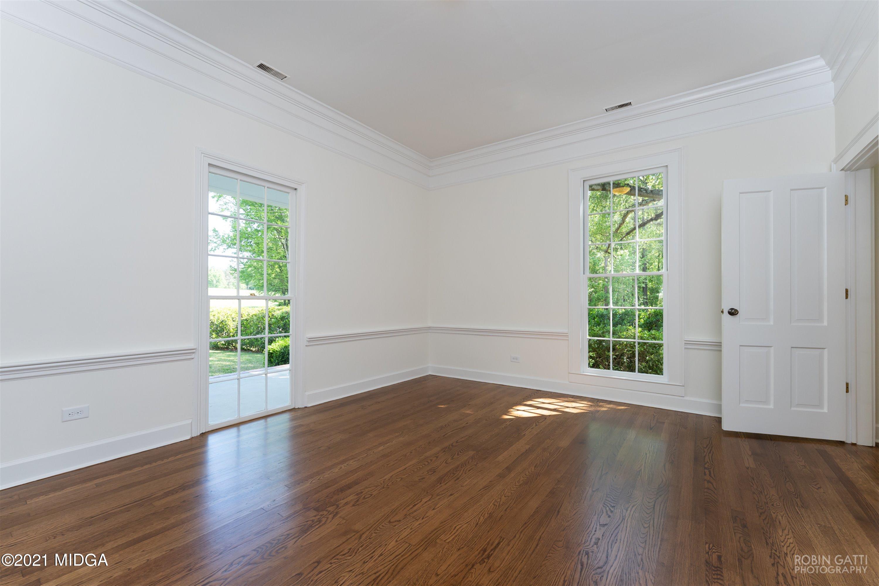 2569 Maynards Mill Road Forsyth, GA 31029 - Photo 44 of 67 an empty room with wooden floor and windows