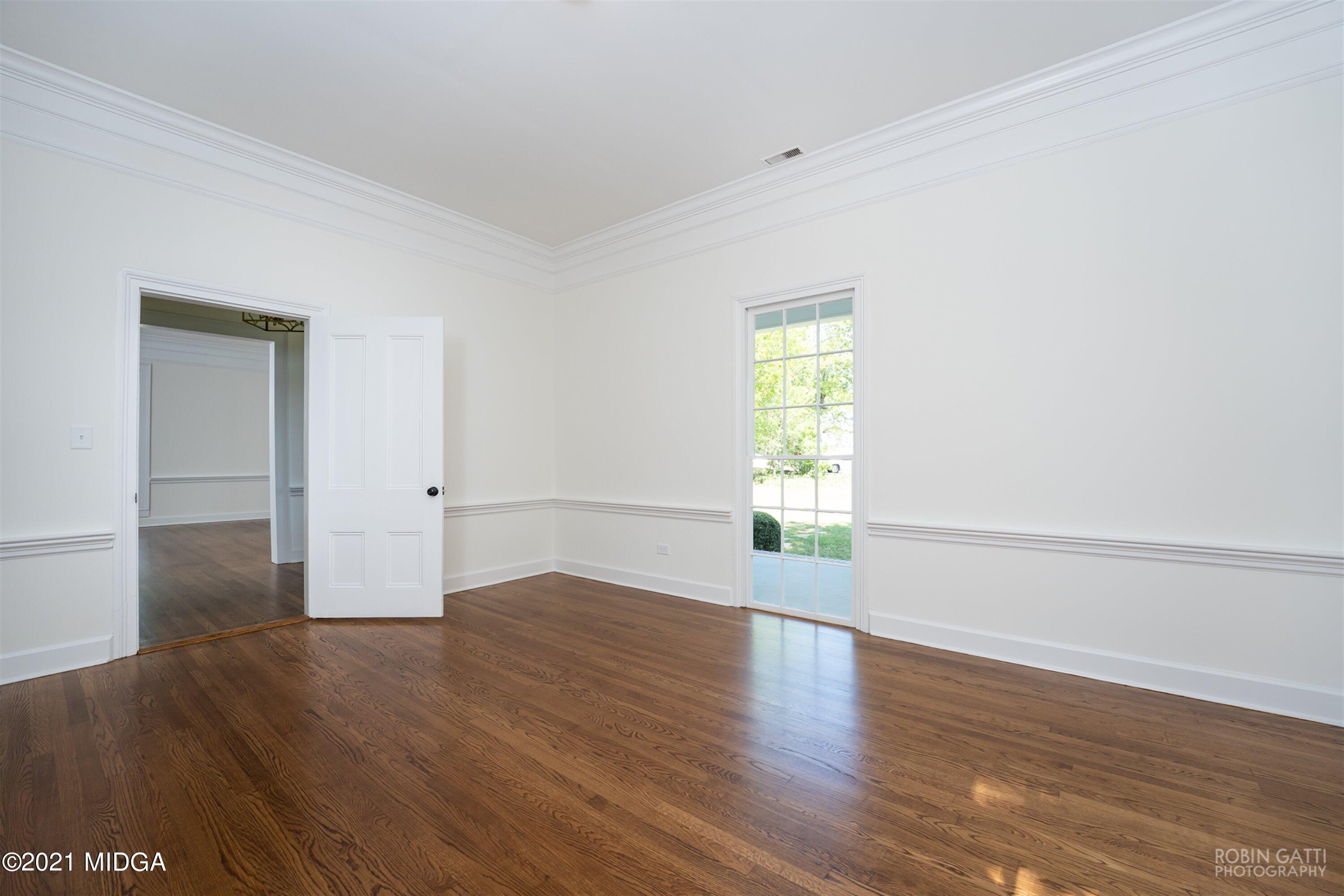 2569 Maynards Mill Road Forsyth, GA 31029 - Photo 46 of 67 an empty room with wooden floor and windows