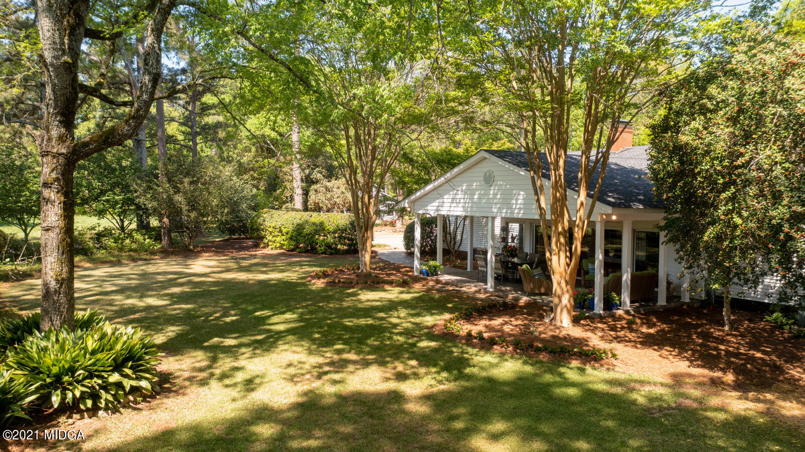 2569 Maynards Mill Road Forsyth, GA 31029 - Photo 60 of 67 a view of a house with a large tree and a yard