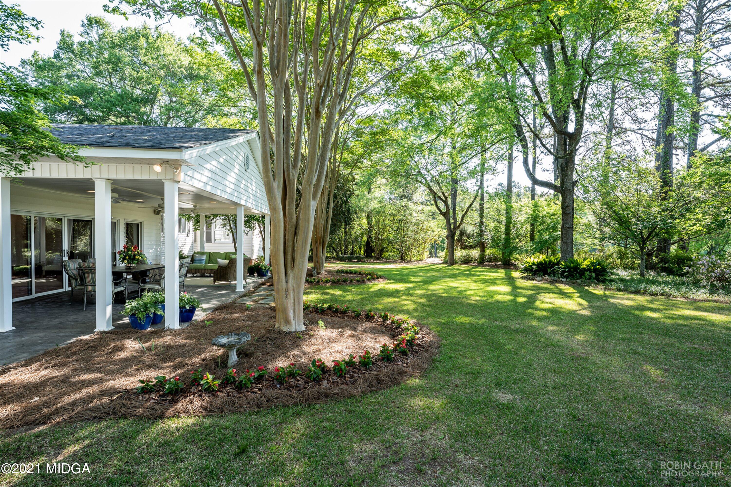 2569 Maynards Mill Road Forsyth, GA 31029 - Photo 10 of 67 a view of a house with backyard and a tree