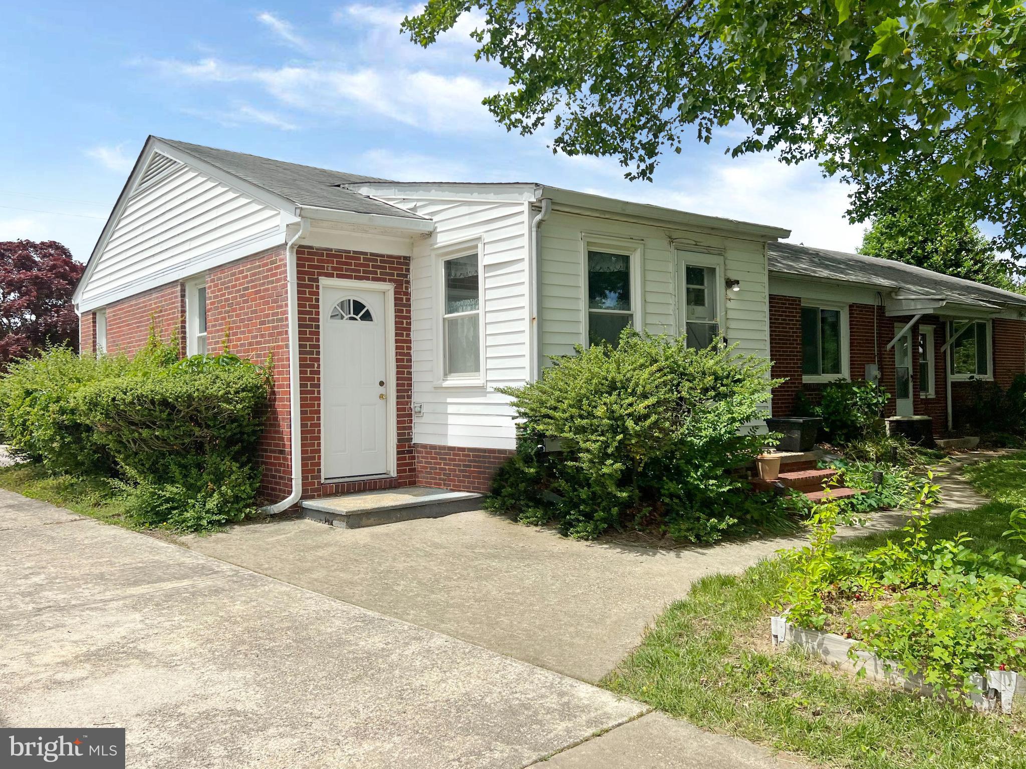 800 Church Hill Road Centreville, MD 21617 - Photo 3 of 19 front view of house with potted plants and a bench