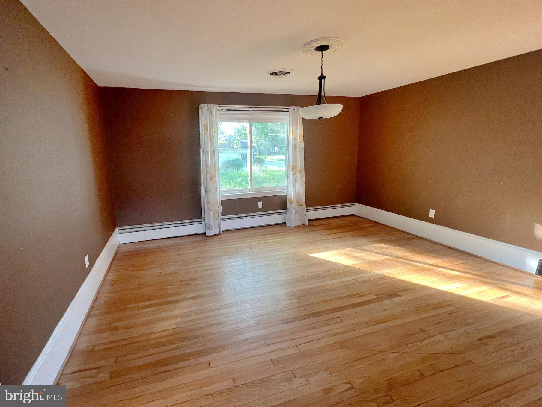 800 Church Hill Road Centreville, MD 21617 - Photo 6 of 19 a view of empty room with wooden floor and fan