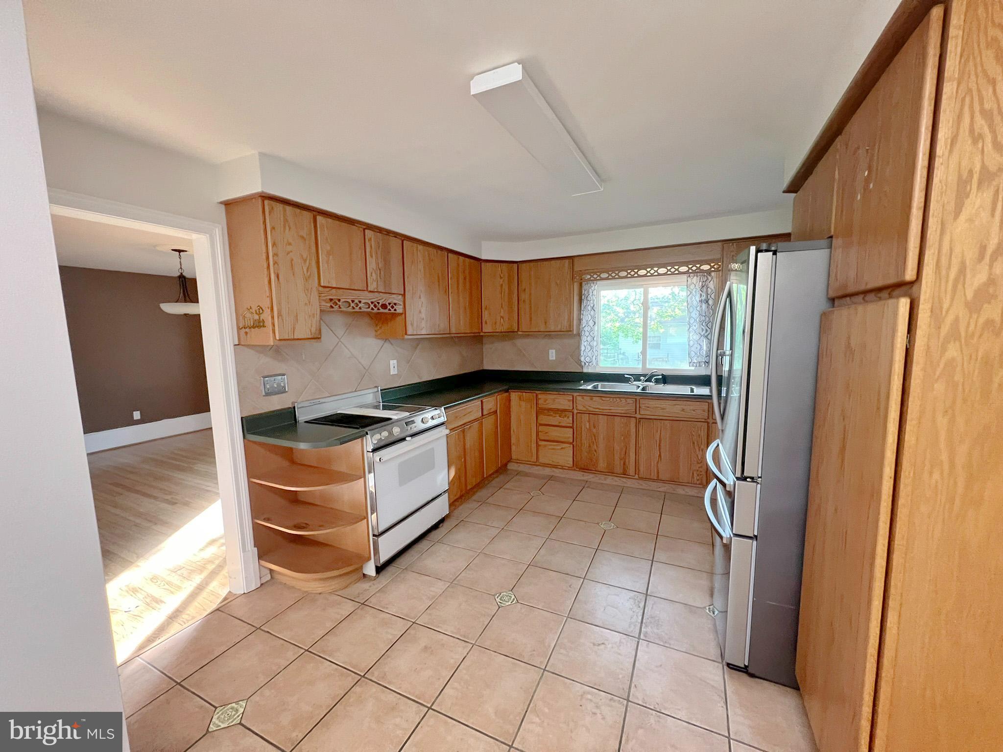 800 Church Hill Road Centreville, MD 21617 - Photo 7 of 19 a kitchen with stainless steel appliances granite countertop a refrigerator and a sink