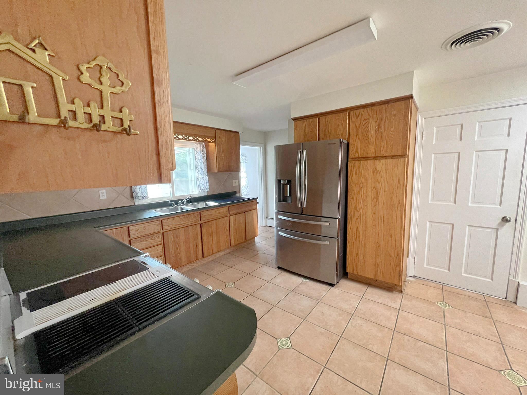 800 Church Hill Road Centreville, MD 21617 - Photo 8 of 19 a kitchen with stainless steel appliances a refrigerator and a stove top oven