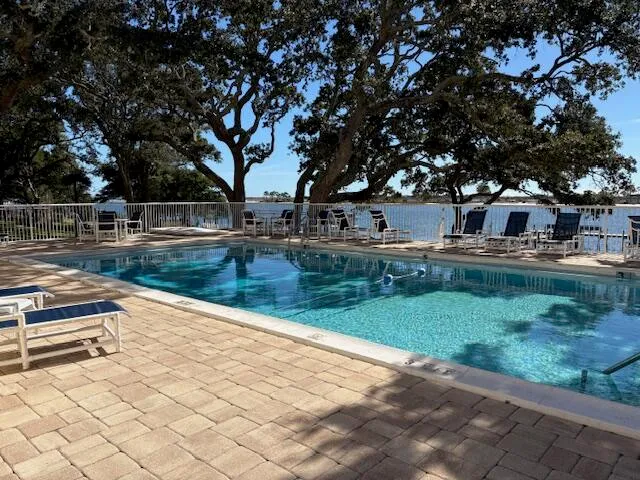 a view of swimming pool with trees in the background