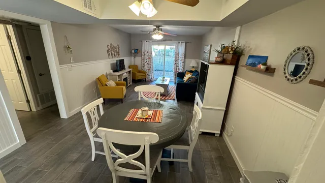 a view of a dining room with furniture and wooden floor