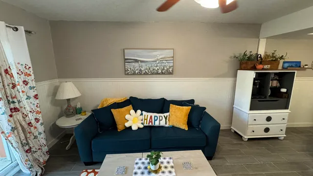 a living room with furniture and flowers