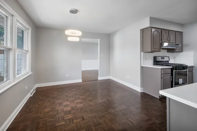 a view of a kitchen with a sink cabinets and wooden floor