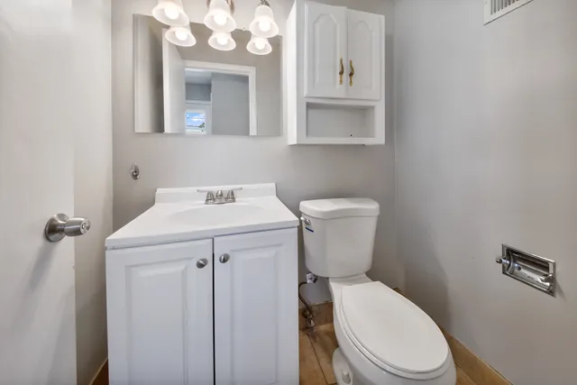 a bathroom with a sink a toilet and mirror