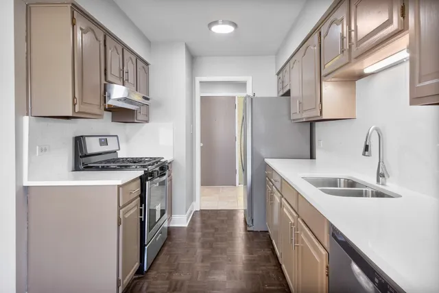 a kitchen with stainless steel appliances granite countertop a sink stove and refrigerator