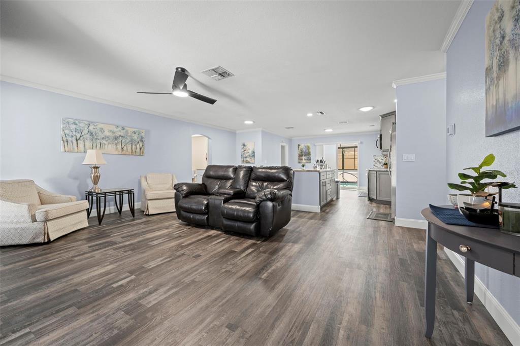 2399 Gallagher Avenue Spring Hill, FL 34606 - Photo 24 of 56 a living room with furniture and wooden floor