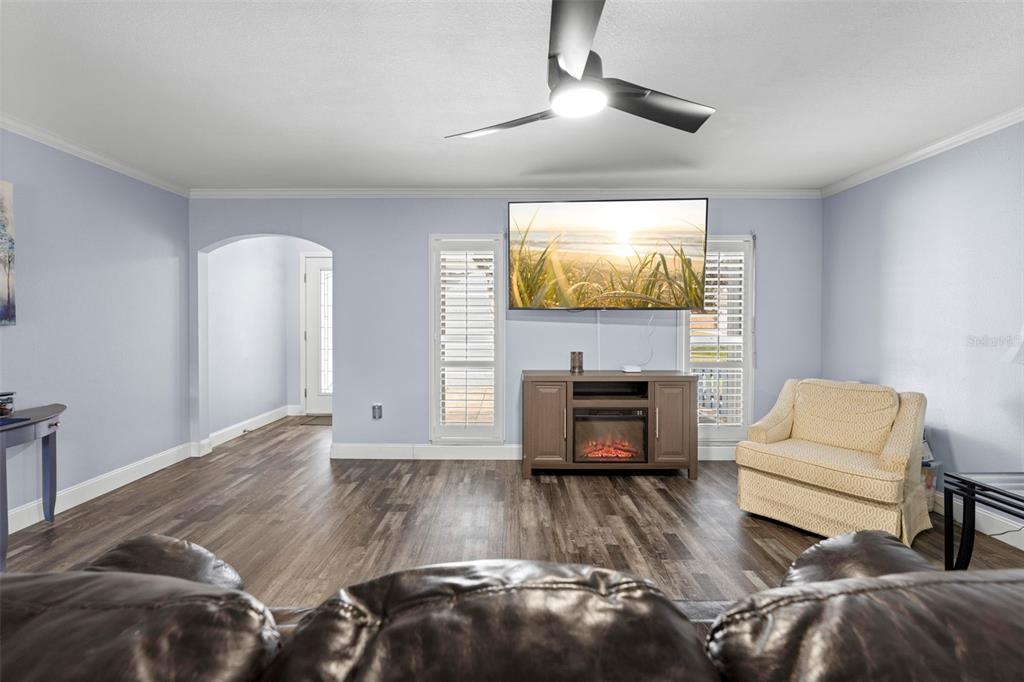 2399 Gallagher Avenue Spring Hill, FL 34606 - Photo 26 of 56 a living room with furniture and a flat screen tv