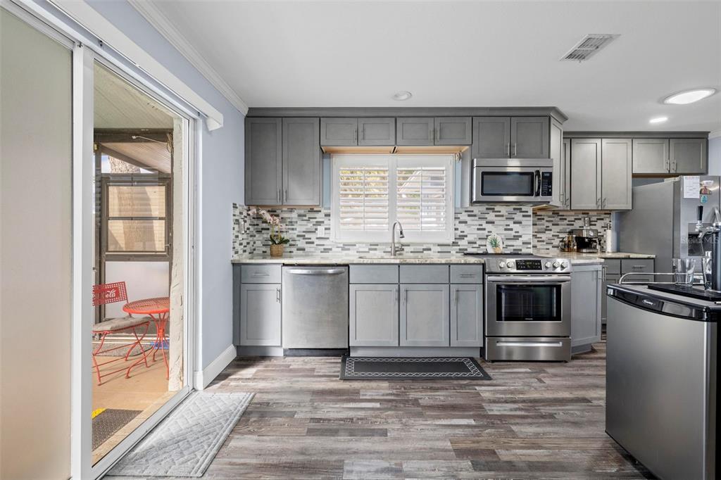 2399 Gallagher Avenue Spring Hill, FL 34606 - Photo 32 of 56 a kitchen with stainless steel appliances a stove sink and refrigerator